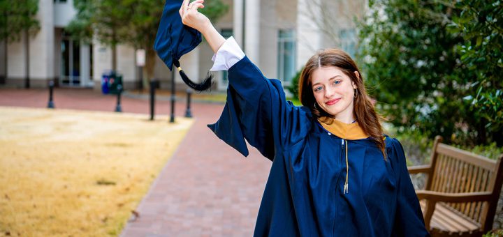 Mack (Mackenzie) Morris 24MAF celebrating the completion of the MAF program wearing a cap and gown