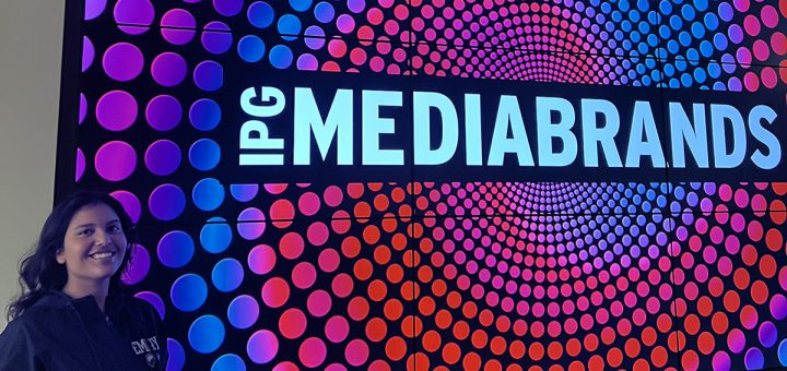 Darisi Garg 26BBA standing in front of IPG Mediabrands sign