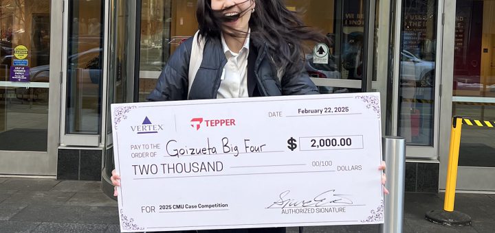 Nathalie Zhou holding check and jumping in celebration